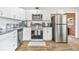 Modern kitchen with stainless steel appliances, white cabinetry, and wood-look flooring at 4057 67Th N Ave, Pinellas Park, FL 33781