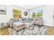 Spacious living room with large windows, comfortable seating, and stylish decor at 4057 67Th N Ave, Pinellas Park, FL 33781