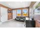 Office space with exposed brick, a modern sofa, desk, and lots of windows at 4057 67Th N Ave, Pinellas Park, FL 33781