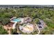 Community center with pool, splash pad, and playground nestled among lush trees and parking at 4094 Braemere Dr, Spring Hill, FL 34609