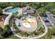 Elevated view of a community water park, splash pad and playground, surrounded by trees and parking at 4094 Braemere Dr, Spring Hill, FL 34609