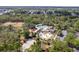 Aerial view showcases community pool, splashpad, playground, volleyball court and wooded scenery at 4094 Braemere Dr, Spring Hill, FL 34609