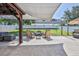 Backyard with brick patio, seating area, and white fence at 4094 Braemere Dr, Spring Hill, FL 34609