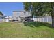 Spacious backyard with a pergola, patio furniture and secure white fence surrounding the property at 4094 Braemere Dr, Spring Hill, FL 34609