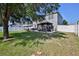 Large fenced backyard featuring a pergola covered patio and ample space for outdoor activities at 4094 Braemere Dr, Spring Hill, FL 34609