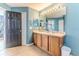 Bathroom featuring a double sink vanity, large mirror, and tiled floors at 4094 Braemere Dr, Spring Hill, FL 34609