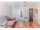 Spacious room with hardwood floors, a leather couch, and a closet at 4094 Braemere Dr, Spring Hill, FL 34609