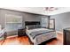 Comfortable bedroom featuring a queen-sized bed, wood floors, and ample natural light at 4094 Braemere Dr, Spring Hill, FL 34609