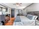 Bedroom with a queen bed, wood floors, a dresser, and an open door to another room at 4094 Braemere Dr, Spring Hill, FL 34609