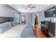 Well-lit bedroom with a bed, wood floors, and a door leading to the ensuite bathroom at 4094 Braemere Dr, Spring Hill, FL 34609