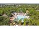 Overhead view showing the community pool and clubhouse, playground and shaded seating areas at 4094 Braemere Dr, Spring Hill, FL 34609