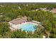 Aerial view features a large, inviting community swimming pool with lounge chairs and shaded pavilion at 4094 Braemere Dr, Spring Hill, FL 34609