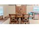 Dining room showcasing a wooden table, chairs, and barn doors, illuminated by a pendant light at 4094 Braemere Dr, Spring Hill, FL 34609
