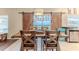 Dining room with a wooden table, chairs, barn doors with view of a fenced yard, and stainless steel appliances at 4094 Braemere Dr, Spring Hill, FL 34609