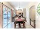 Dining area with a wooden table, chairs, and sliding barn doors leading to an outdoor patio and kitchen at 4094 Braemere Dr, Spring Hill, FL 34609