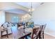 Charming dining room with hardwood floors, wooden table, and a view into the cozy living room at 4094 Braemere Dr, Spring Hill, FL 34609