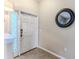 Bright entryway featuring neutral colors, a transom window, and ceramic tile floors at 4094 Braemere Dr, Spring Hill, FL 34609