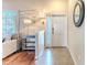 Inviting entryway with ceramic tile flooring, coat closet, modern lighting and mirror at 4094 Braemere Dr, Spring Hill, FL 34609