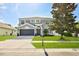 Beautiful two-story home with a well-maintained lawn, two-car garage, and a lovely tree in the front yard at 4094 Braemere Dr, Spring Hill, FL 34609