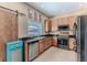 Kitchen featuring stainless steel appliances, wooden cabinets, granite countertops, and modern fixtures at 4094 Braemere Dr, Spring Hill, FL 34609