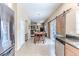 Kitchen and dining area showcasing stainless steel appliances and access to the living room in an open-concept design at 4094 Braemere Dr, Spring Hill, FL 34609