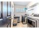 Bright laundry room with modern washer and dryer, storage and organization at 4094 Braemere Dr, Spring Hill, FL 34609