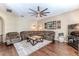 Spacious living room featuring hardwood floors, a comfortable sectional sofa, modern lighting, and ceiling fan at 4094 Braemere Dr, Spring Hill, FL 34609
