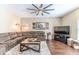 Spacious living room with a large sectional, wood floors, and a decorative ceiling fan at 4094 Braemere Dr, Spring Hill, FL 34609