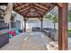 Backyard brick patio with covered pergola and outdoor seating at 4094 Braemere Dr, Spring Hill, FL 34609