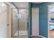 Modern tiled shower featuring a glass door enclosure and a dual shower head at 4094 Braemere Dr, Spring Hill, FL 34609