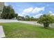 Wide shot of expansive green lawn enclosed by a white vinyl fence under a blue sky at 4215 Maplehurst Way, Spring Hill, FL 34609