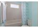 Bright bathroom with a shower-tub combo and a window at 4215 Maplehurst Way, Spring Hill, FL 34609