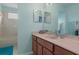 Bright bathroom featuring a vanity with dual mirrors and a combined shower and tub at 4215 Maplehurst Way, Spring Hill, FL 34609