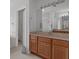 Bathroom featuring dual sink vanity with warm cabinets and a separate shower and soaking tub at 4215 Maplehurst Way, Spring Hill, FL 34609