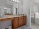 Bathroom featuring dual sinks with vanity and countertop space with a shower and tub combination at 4215 Maplehurst Way, Spring Hill, FL 34609