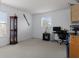 Bright bedroom with large window, neutral carpet, and a dark-wood display cabinet at 4215 Maplehurst Way, Spring Hill, FL 34609