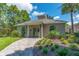 Charming clubhouse exterior surrounded by lush landscaping and a welcoming walkway, ideal for community gatherings at 4215 Maplehurst Way, Spring Hill, FL 34609