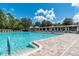 Large community pool featuring brick pavers, clear blue water and lounge seating for relaxation at 4215 Maplehurst Way, Spring Hill, FL 34609