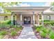 Inviting community center entrance featuring brick accents, classic lighting fixtures and well-manicured landscaping at 4215 Maplehurst Way, Spring Hill, FL 34609
