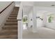 Bright and open foyer with staircase and views into the living areas at 4215 Maplehurst Way, Spring Hill, FL 34609