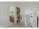Upstairs hallway featuring neutral carpet leading to a full bath and a staircase at 4215 Maplehurst Way, Spring Hill, FL 34609