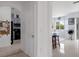 Hallway view leading to a modern kitchen, with white cabinetry and stainless steel appliances at 4215 Maplehurst Way, Spring Hill, FL 34609