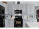 Kitchen featuring gray cabinets, stainless steel appliances, and modern backsplash and countertops at 4215 Maplehurst Way, Spring Hill, FL 34609