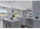 Bright kitchen featuring granite countertops and stainless steel appliances overlooking the backyard at 4215 Maplehurst Way, Spring Hill, FL 34609