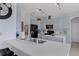 Open kitchen featuring a large island, stainless steel appliances, and modern countertops at 4215 Maplehurst Way, Spring Hill, FL 34609