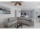 Open living room seamlessly connected to a modern kitchen with a breakfast bar and dining area at 4215 Maplehurst Way, Spring Hill, FL 34609