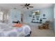 Beautiful main bedroom with TV, shelving decor, and calming blue walls at 4215 Maplehurst Way, Spring Hill, FL 34609