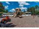 Bright playground with slides, climbing structure, and other play features set in a wood chip ground at 4215 Maplehurst Way, Spring Hill, FL 34609