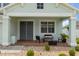 Relaxing covered porch featuring comfortable seating and a decorative planter at 4215 Maplehurst Way, Spring Hill, FL 34609