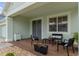 Inviting covered porch with stylish seating area and decorative plants at 4215 Maplehurst Way, Spring Hill, FL 34609